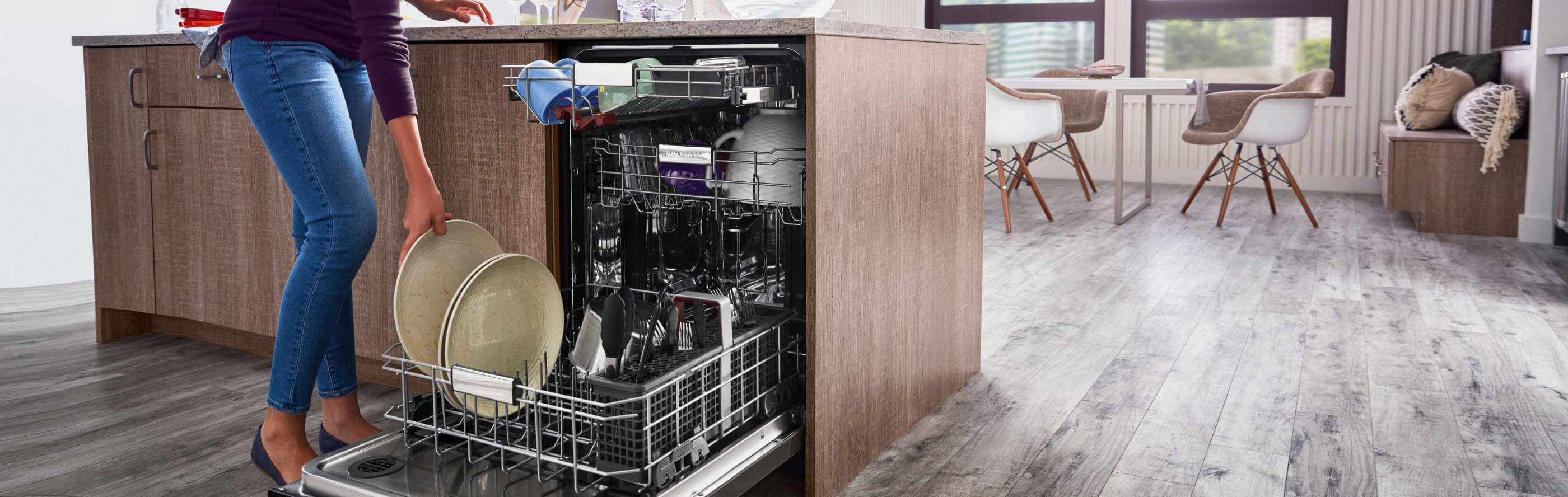 Person loading dishes into a dishwasher