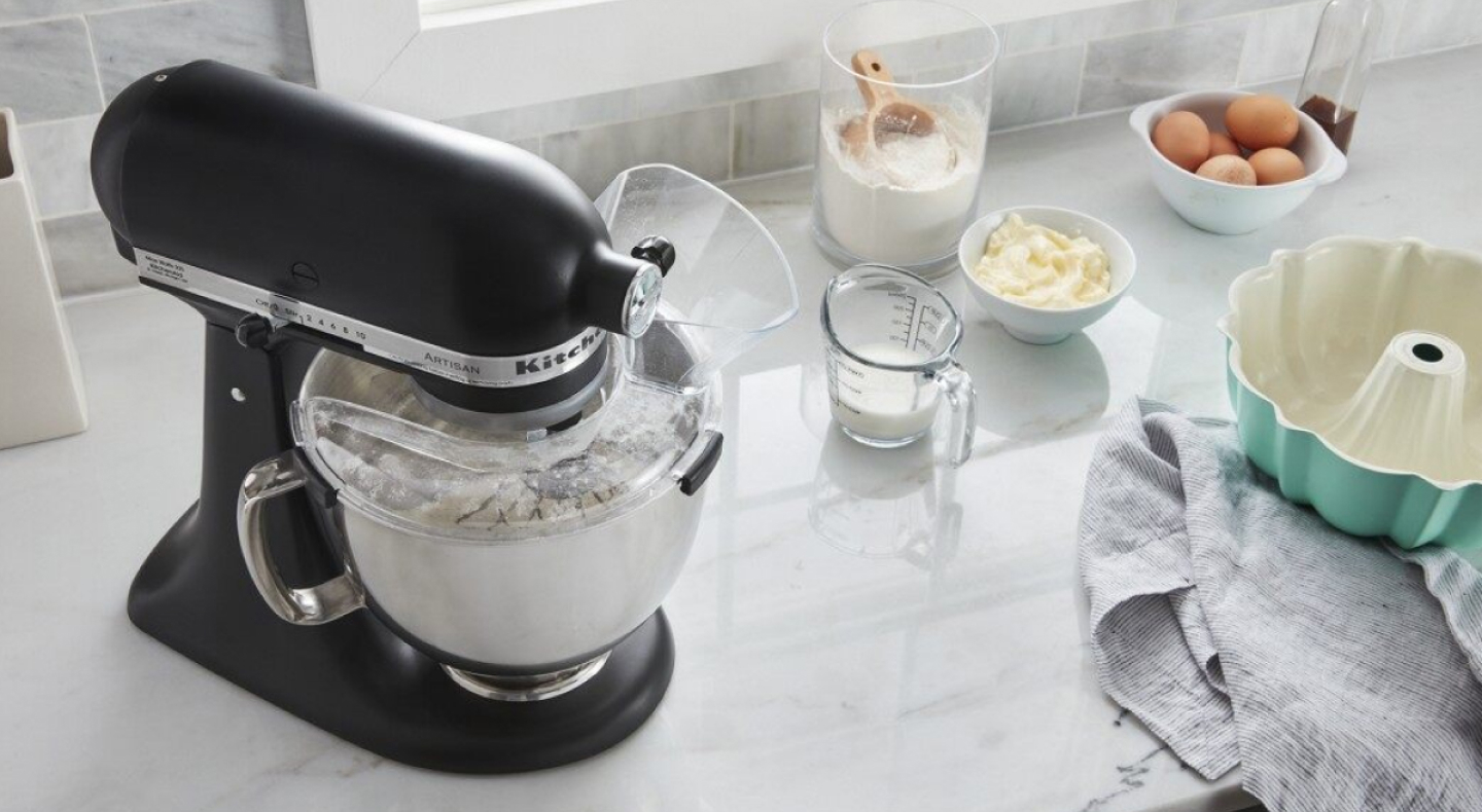 A black KitchenAid® stand mixer and various kitchen items on a countertop  A black KitchenAid® stand mixer and various kitchen items on a countertop