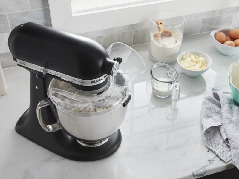 A black KitchenAid® stand mixer and various kitchen items on a countertop  A black KitchenAid® stand mixer and various kitchen items on a countertop