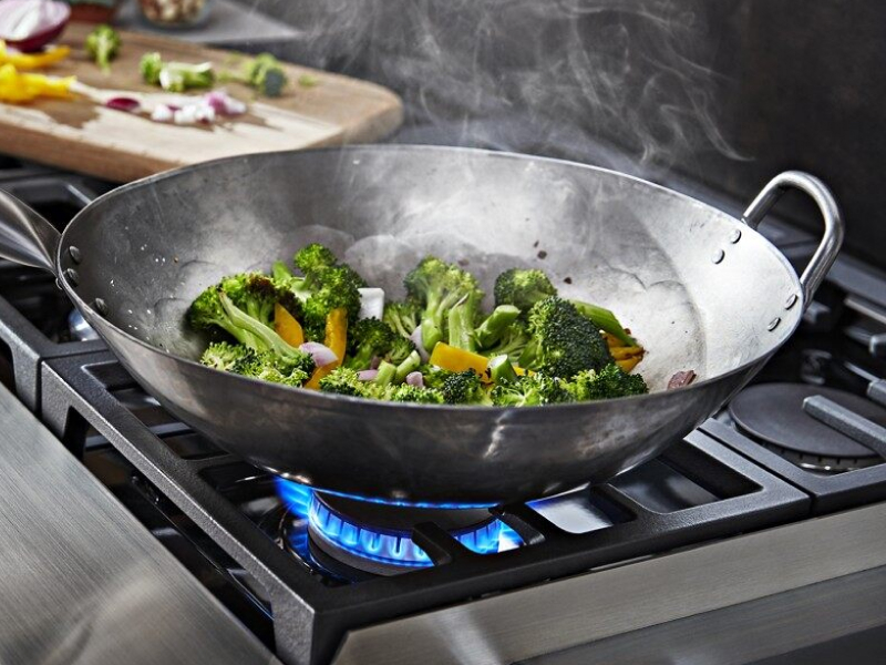 Broccoli simmering on a gas stovetop