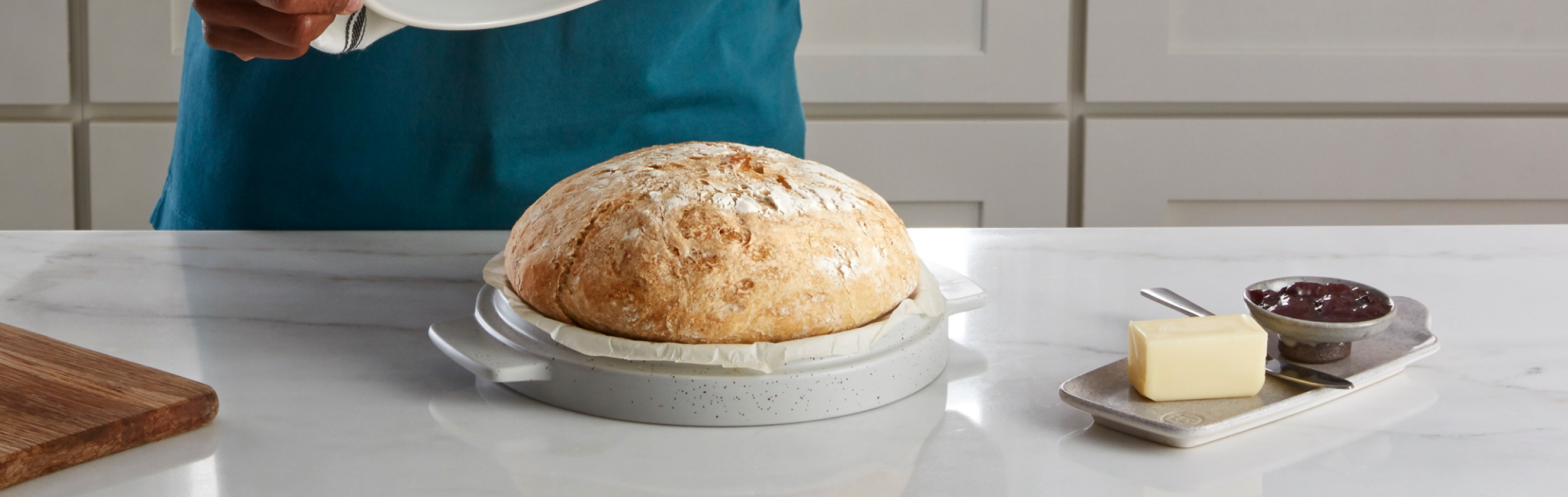 Homemade artisanal bread in a KitchenAid® Bread Bowl on a modern kitchen counter