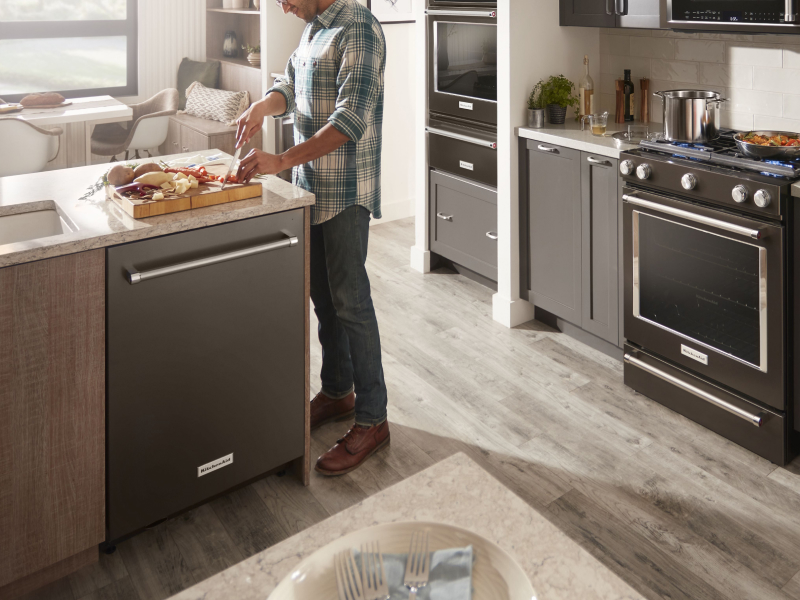 Person cutting vegetables at a kitchen island Person cutting vegetables at a kitchen island