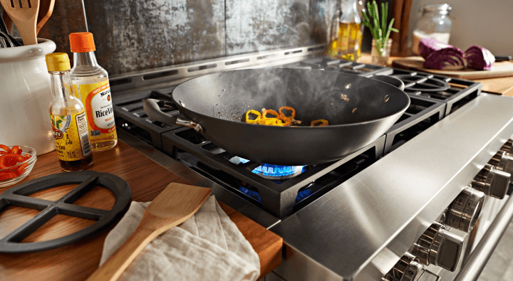 Food cooking in a pan on a gas stove