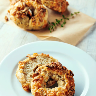 Sliced bagel topped with toasted cheese