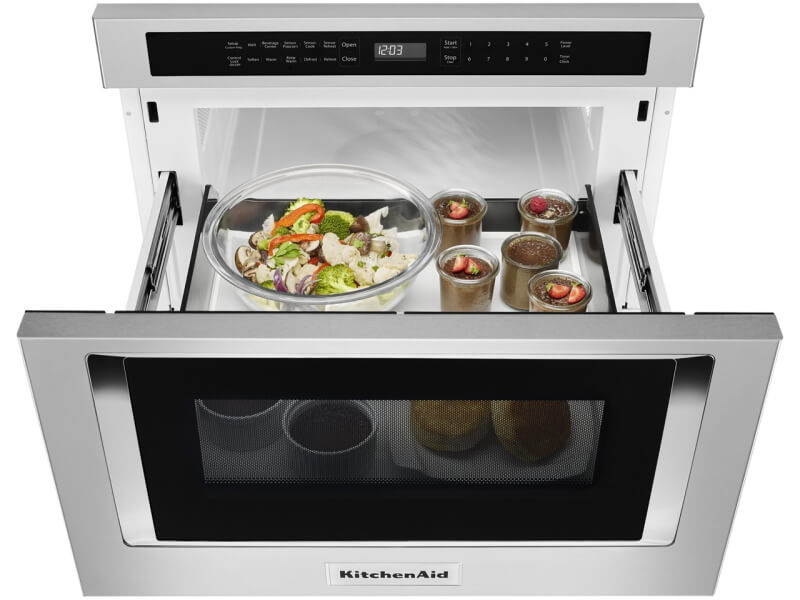 An open KitchenAid® undercounter microwave oven drawer with an assortment of food inside An open KitchenAid® undercounter microwave oven drawer with an assortment of food inside