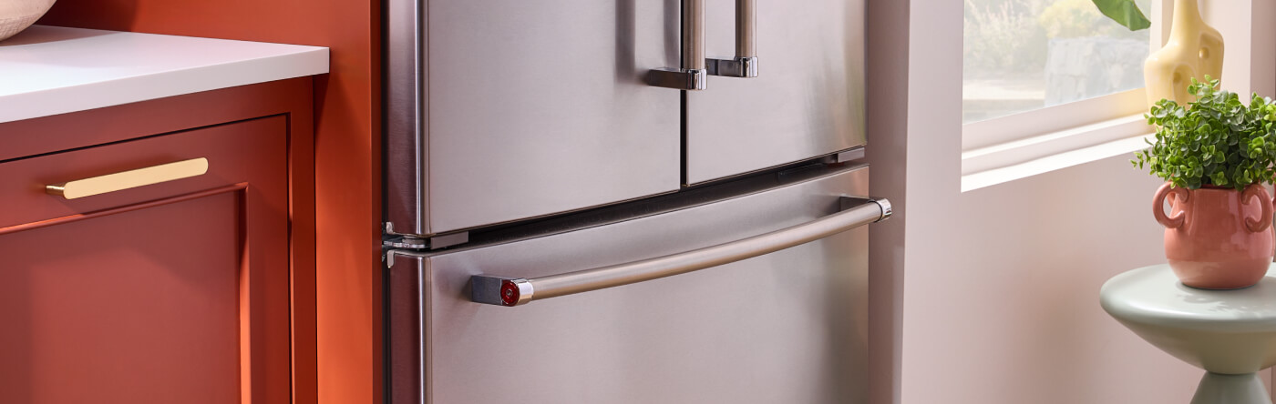 A KitchenAid® French door refrigerator next to terracotta cabinets