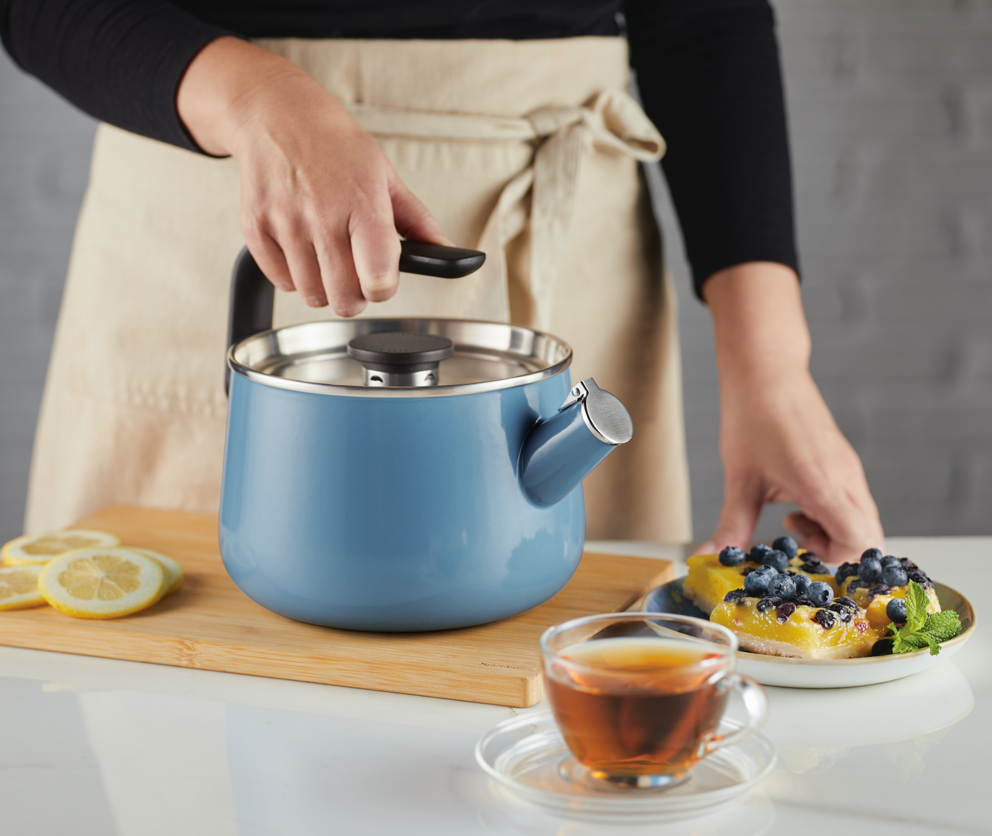 Person brewing hot water for tea with a KitchenAid® Stovetop Kettle.