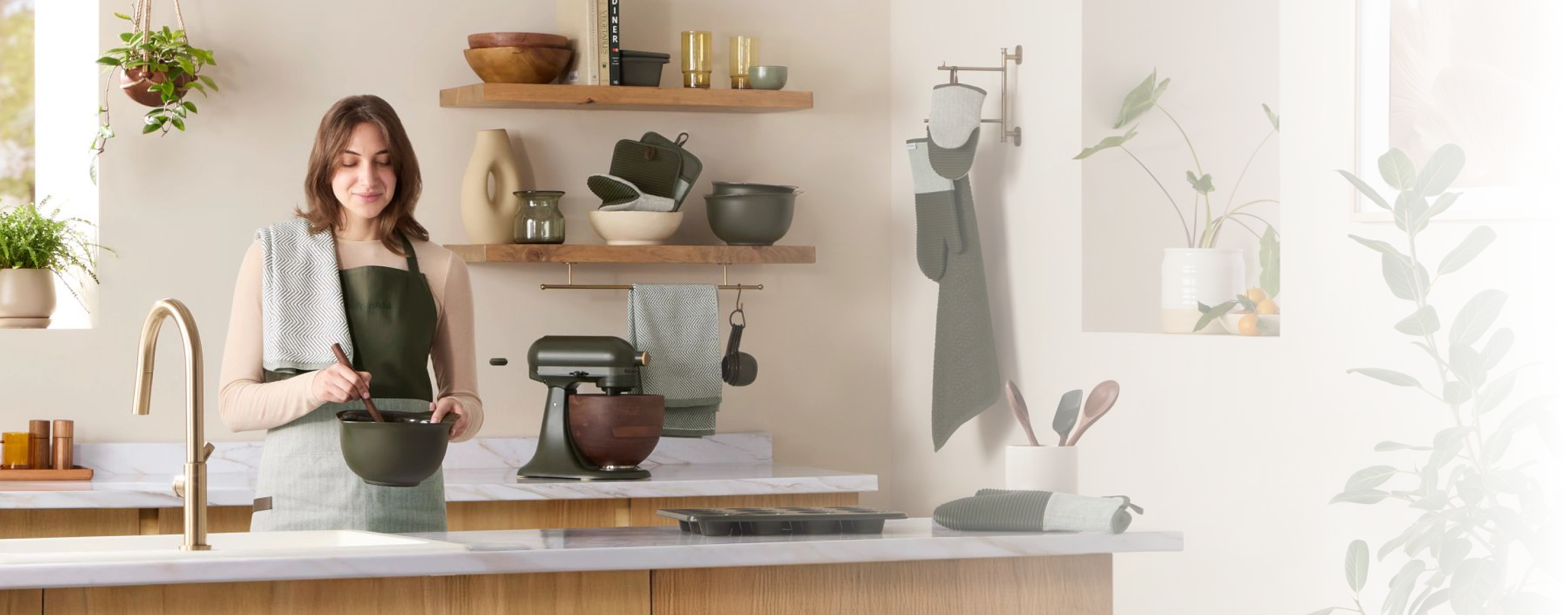 A person preparing food with an KitchenAid® Evergreen Stand Mixer.