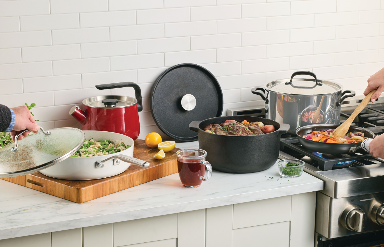 People preparing a meal in a with KitchenAid® Cookware and Kettles
