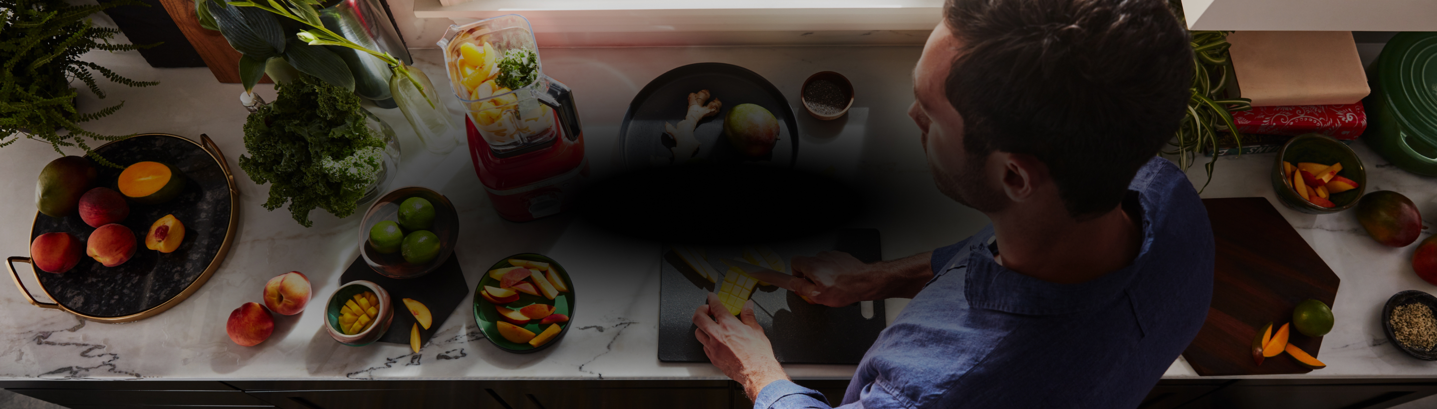 A person cutting fruit for a smoothie