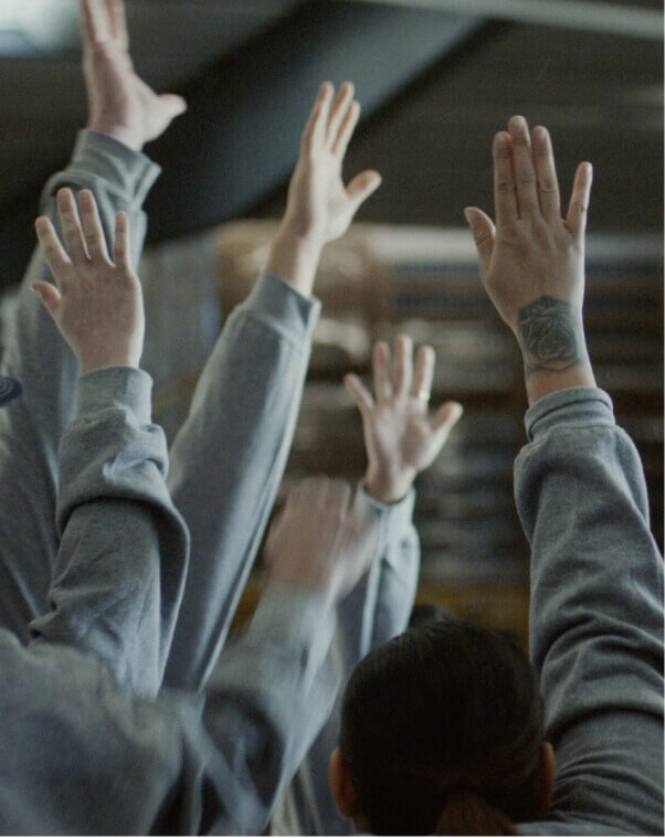 Workers eagerly raising their hands.