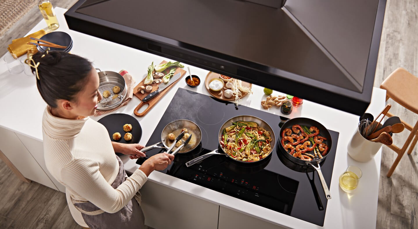 Person cooking on an induction cooktop