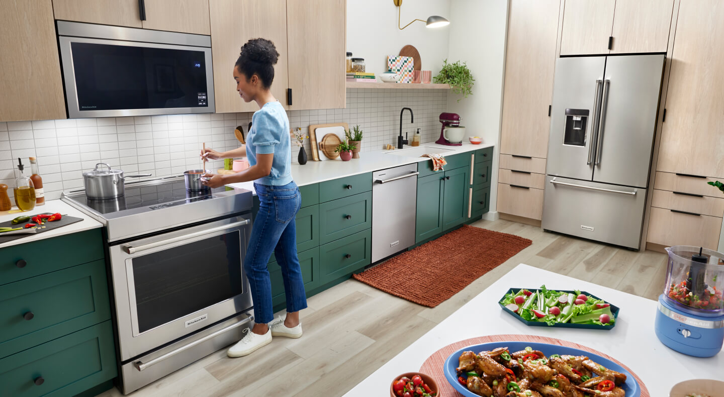 Person cooking on an induction cooktop in a modern kitchen