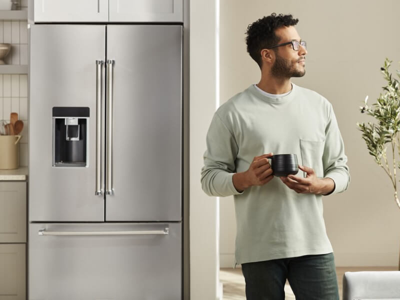 Person standing in front of a built-in refrigerator