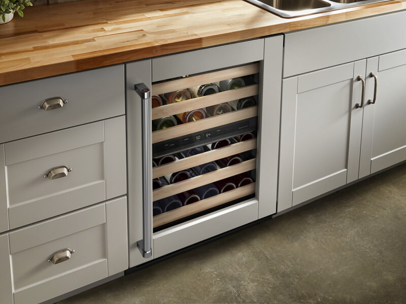 Undercounter refrigerator set in gray cabinetry