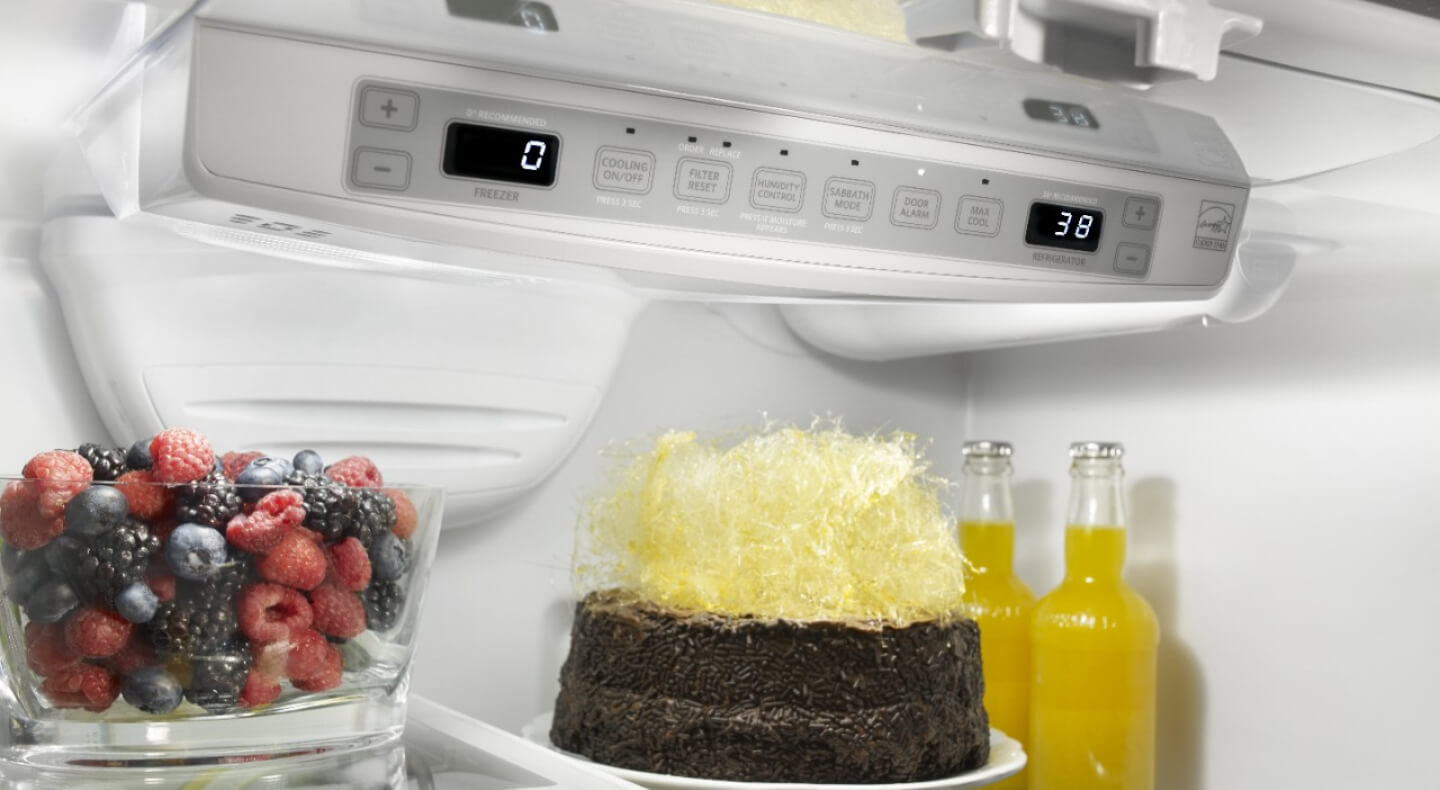 Dessert, fruit and glass bottles in a refrigerator
