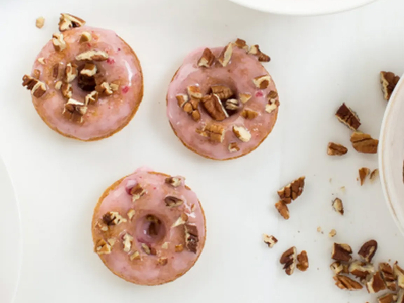 Donuts with pink glaze and pecans