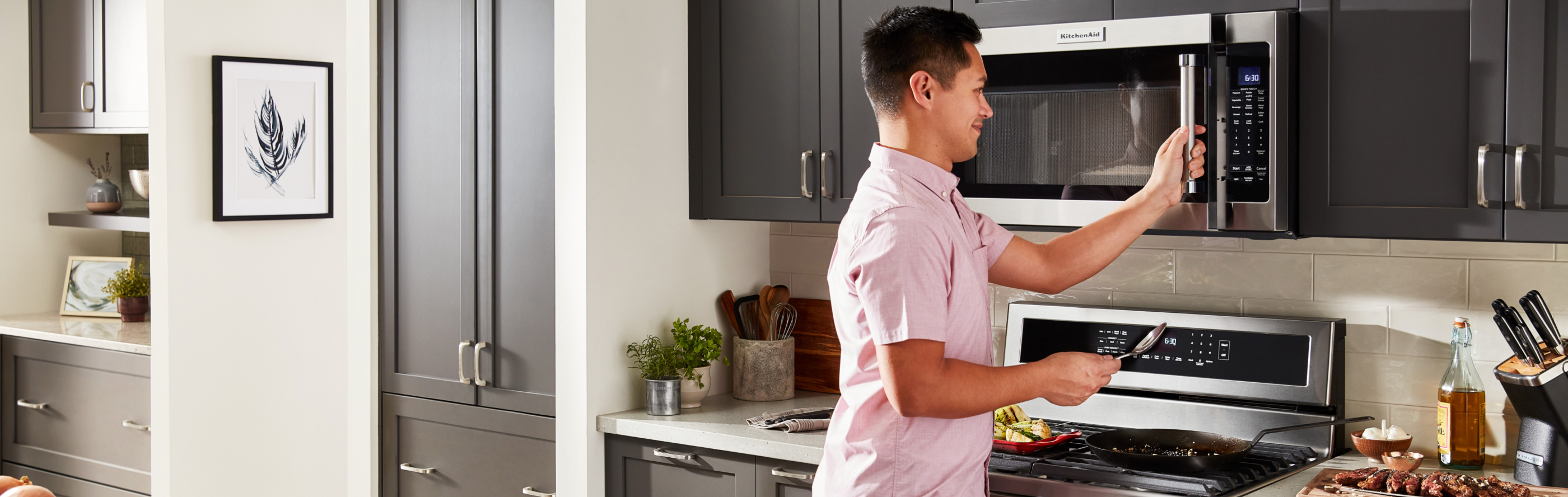 Person opening KitchenAid brand microwave