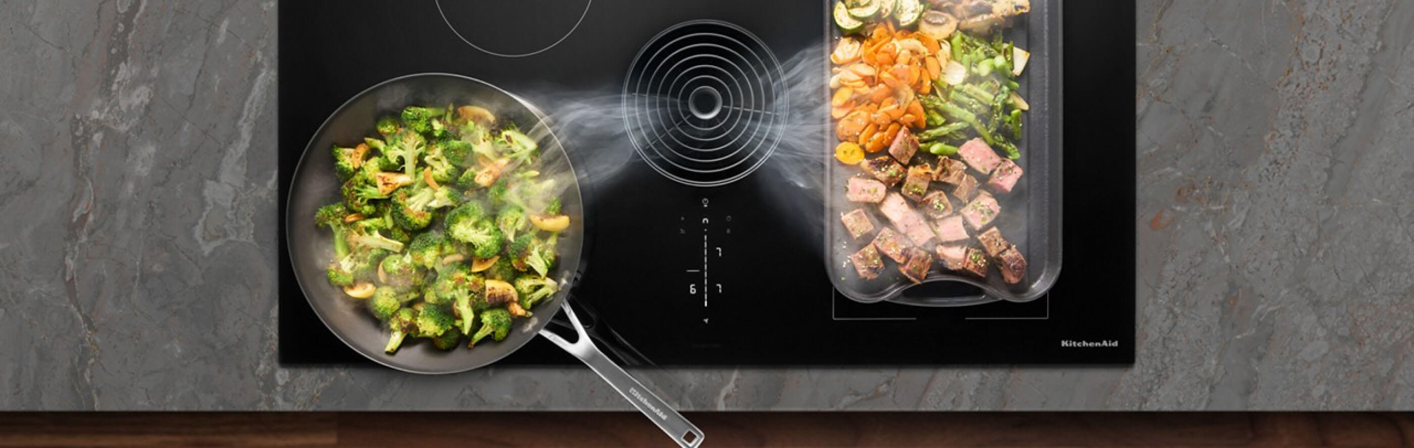 Overhead view of food cooking on an induction cooktop