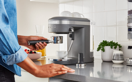 Person placing a portafilter on a semi-automatic espresso machine