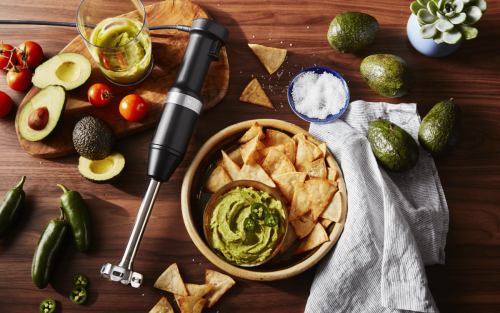 Guacamole and chips next to KitchenAid® hand blender