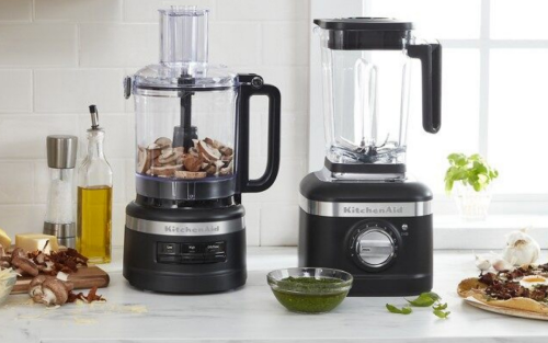 Black KitchenAid® stand mixer, food processor and blender on countertop with ingredients