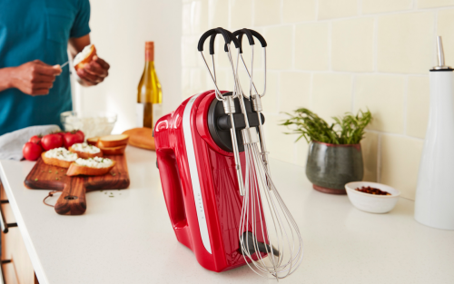 Red KitchenAid® hand mixer with beaters