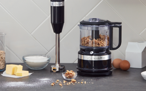 A KitchenAid® food processor and immersion blender on a countertop