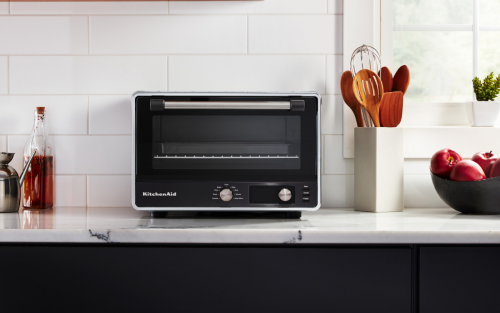 A KitchenAid® countertop oven on a white countertop