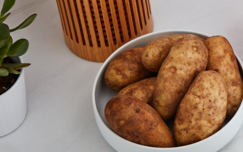 Baked potatoes in a dish on countertop