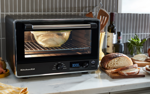 Different foods next to a countertop oven