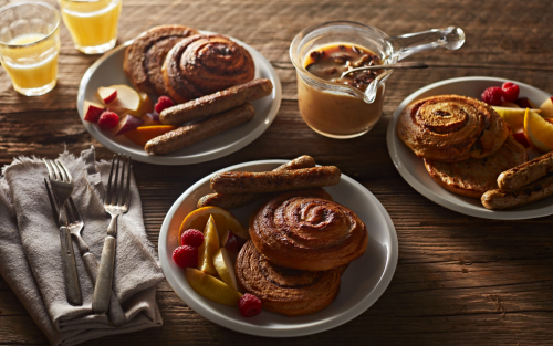 Homemade French toast in a bowl with fresh fruits and sausage