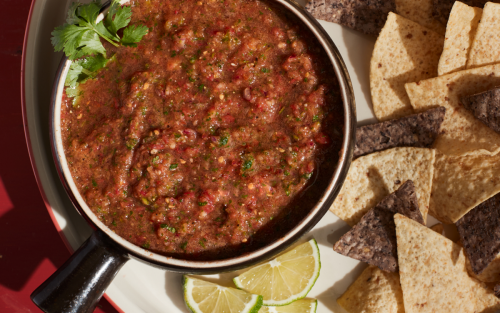 A bowl of blender salsa and chips