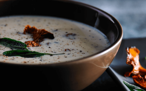 Close-up of blended soup with seasonings in a bowl