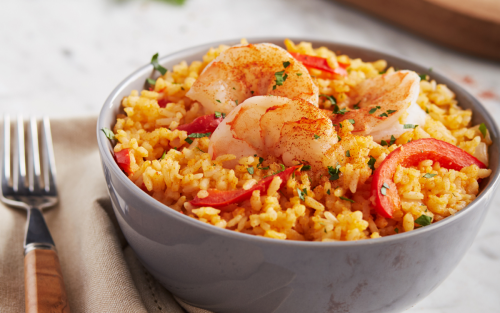 Spanish rice topped with shrimp