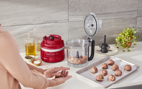 A countertop with the tools and ingredients needed to make a minced chicken recipe