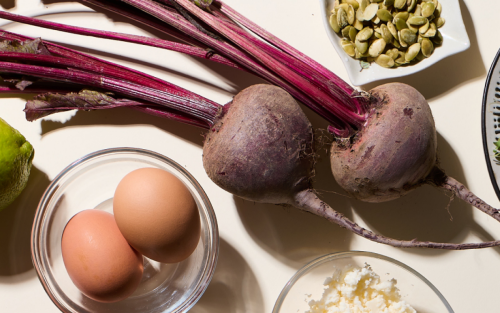 Beetroot on countertop surrounded by a variety of fresh ingredients