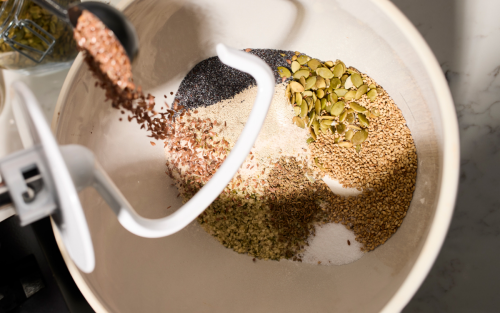 Grains being added to a KitchenAid® stand mixer.