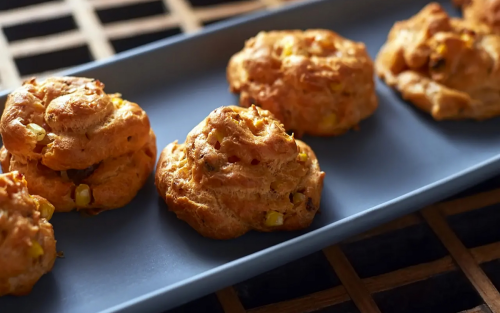 Three baked pastries on a baking sheet