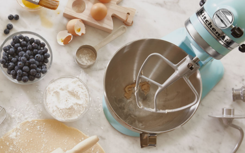 Blue KitchenAid® stand mixer next to pastry ingredients