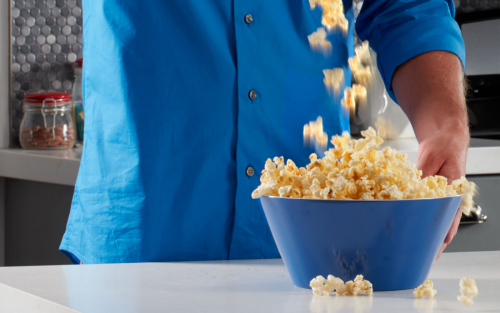 Blue bowl of popcorn on a countertop