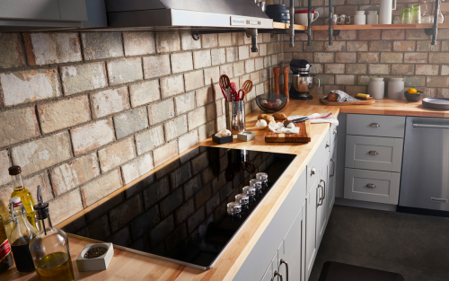 A black electric cooktop on a countertop