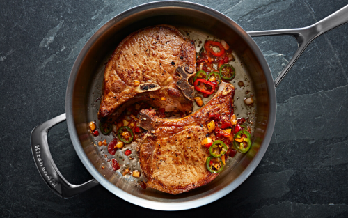 Steak in a KitchenAid® pan with various garnishes