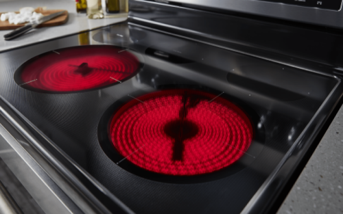 Close-up of an electric stovetop burner red with heat