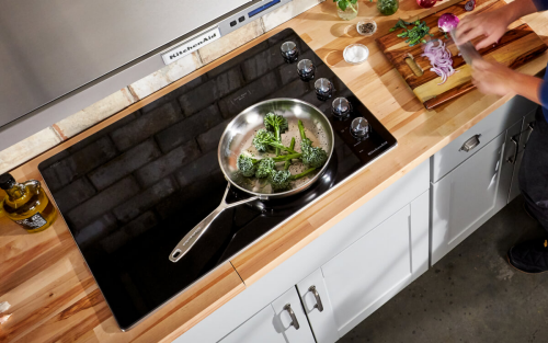 Vegetables sizzling on a cooktop