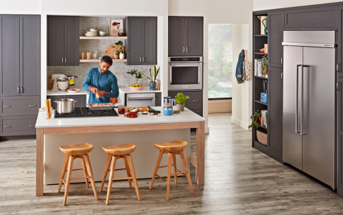 Man cooking on kitchen island cooktop