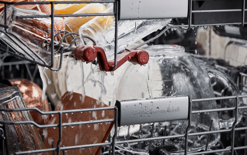 Dishes being cleaned inside a dishwasher