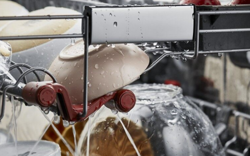 A closeup of the interior of a KitchenAid® dishwasher during a wash cycle.