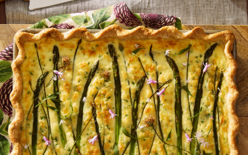 Quiche with asparagus, garnished with edible flowers