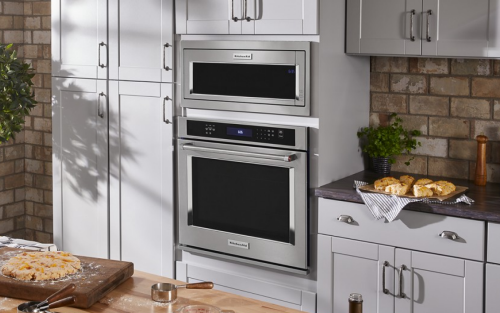 Kitchen with KitchenAid® combination wall oven set in white cabinets